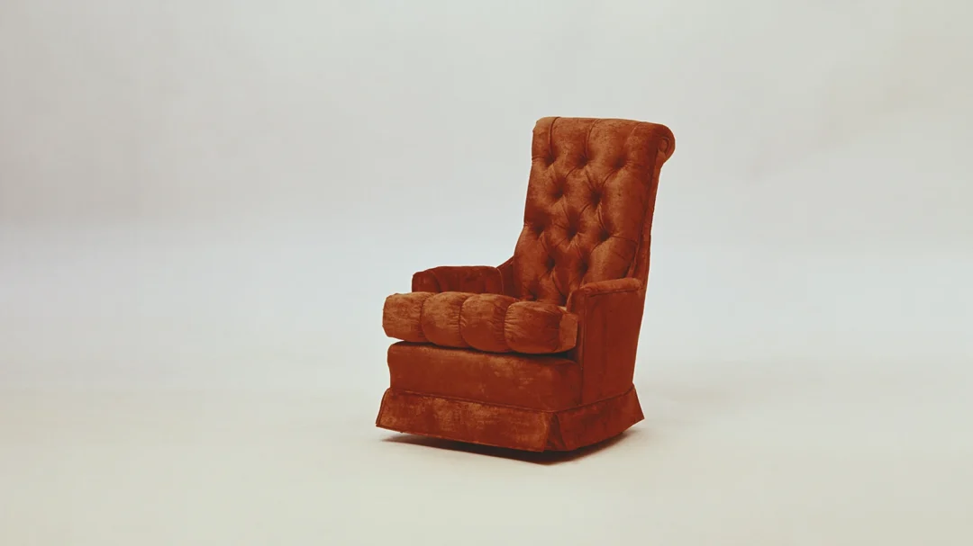 A high-backed, burnt orange velvet riser recliner chair with button-back detailing, representing the specialist mobility furniture that achieved a 501% increase in conversion value through Repeat Digital's marketing strategy.