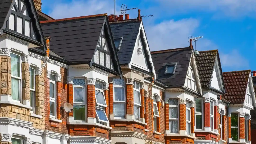 A row of well-maintained traditional red-brick terraced houses with gabled roofs, representing the residential property sectors targeted by Repeat Digital’s 239% conversion-growth strategy for Premier Contractors.