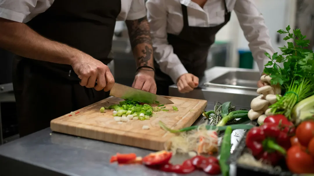 Professional chefs preparing fresh ingredients in a commercial kitchen, representing the hospitality sector targeted by Repeat Digital’s lead generation strategy for Navitas Safety.