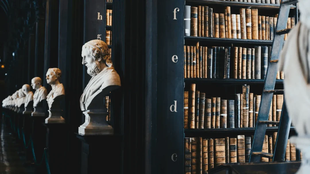 An atmospheric view of a historic library with old leather-bound books and classical busts, representing the deep-rooted authority and expertise Repeat Digital builds for legal brands.