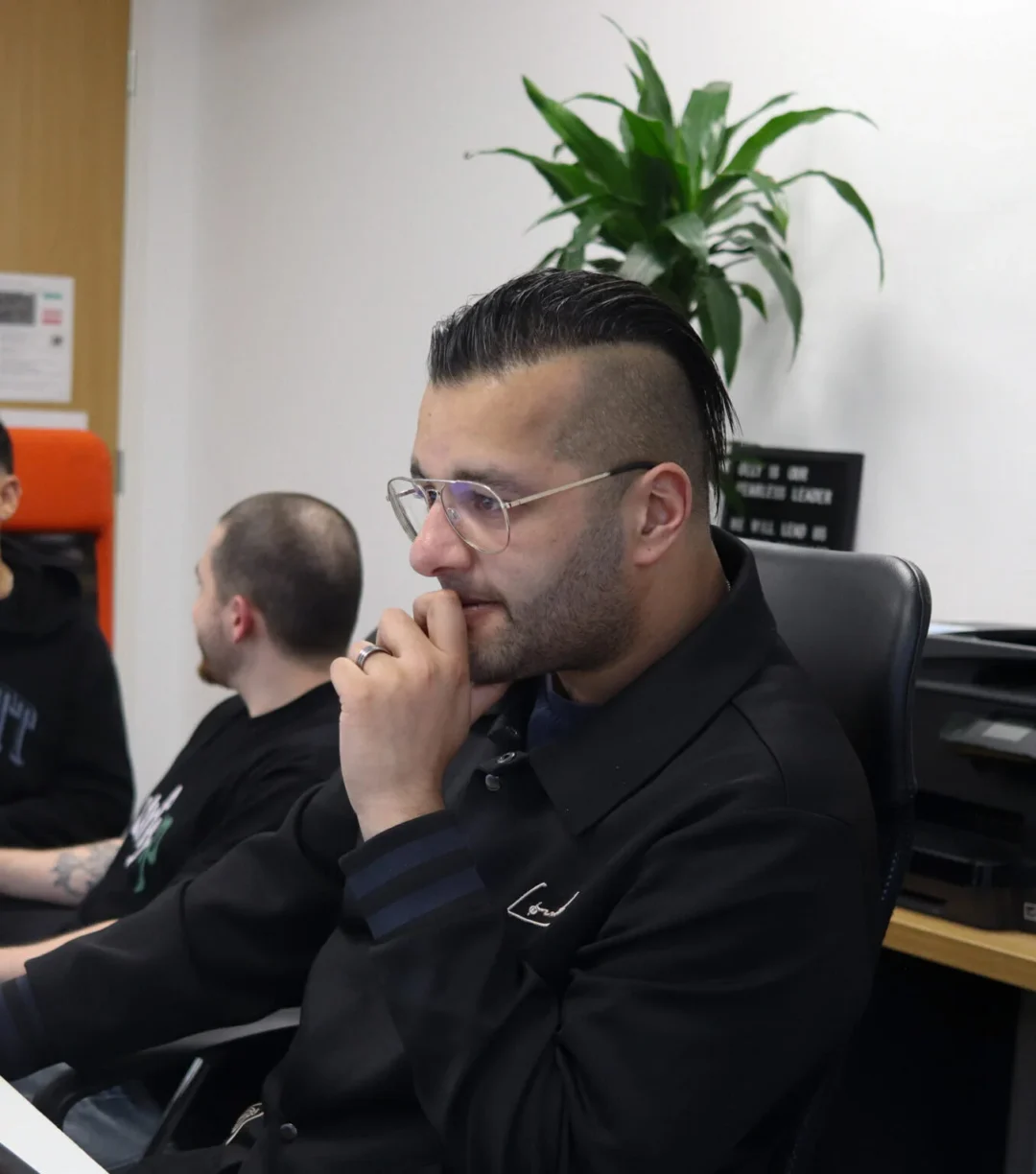 A LinkedIn ads expert at Repeat Digital in a thoughtful pose, demonstrating the deep analysis and strategic planning behind B2B marketing campaigns.