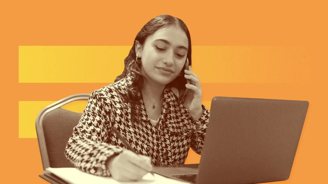 A digital marketing specialist conducting a B2B strategy consultation on the phone while working on a laptop, representing dedicated LinkedIn ads management.