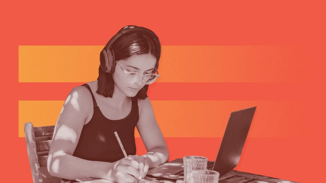 An SEO copywriting specialist wearing headphones and focused on writing high-quality, optimised website content for a client.