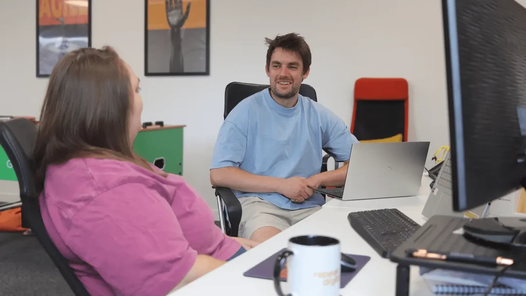 Two Repeat Digital specialists collaborating on a WordPress SEO strategy at a workstation in the Nottingham office.